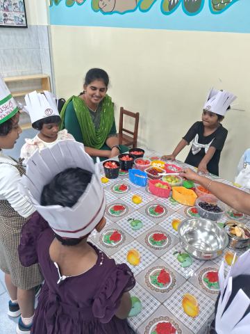 Paper chef hats on for a fruit-sorting activity